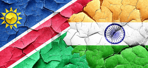 Namibia flag with India flag on a grunge cracked wall
