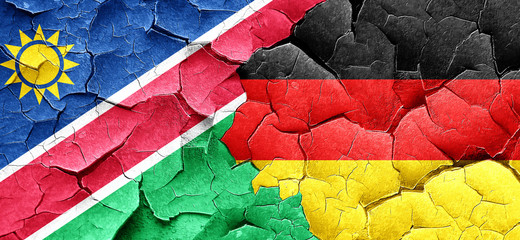 Namibia flag with Germany flag on a grunge cracked wall