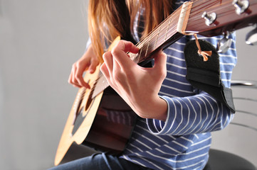 teenager girl playing guitar