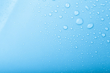 Drops of water on a color background. Blue. Selective focus. Ton