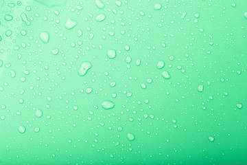 Drops of water on a color background. Green. Selective focus. To