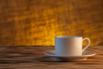 Cup of tea on light wooden table on blur jute background. Select