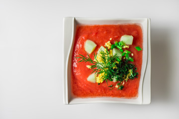 Vegetable soup gazpacho in a porcelain plate