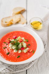 Vegetable soup gazpacho, stand, white bread on the boards