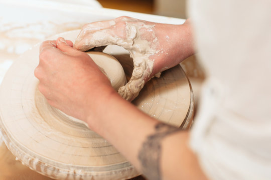 Potter hands shaping clay top view. Closeup on artisan hands making pottery. Art therapy process