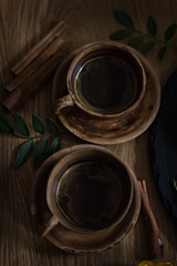 .coffee in clay cups. coffee with cinnamon. Rustic. dark photo.