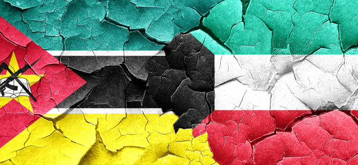 Mozambique flag with Kuwait flag on a grunge cracked wall