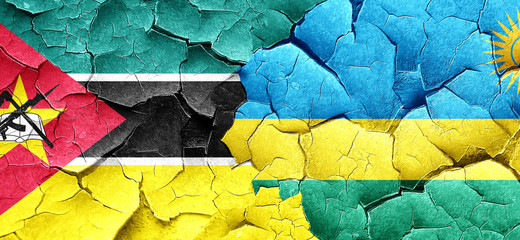 Mozambique flag with rwanda flag on a grunge cracked wall