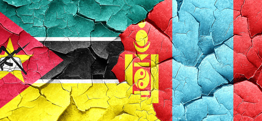 Mozambique flag with Mongolia flag on a grunge cracked wall
