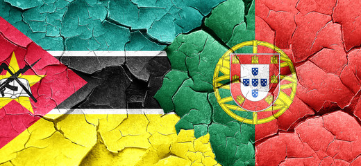 Mozambique flag with Portugal flag on a grunge cracked wall
