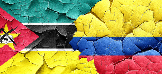 Mozambique flag with Colombia flag on a grunge cracked wall