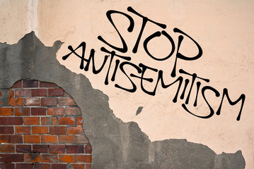 Stop Antisemitism - handwritten graffiti sprayed on the wall, anarchist aesthetics. Appeal to fight...
