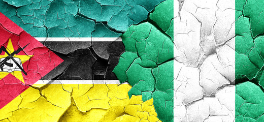 Mozambique flag with Nigeria flag on a grunge cracked wall