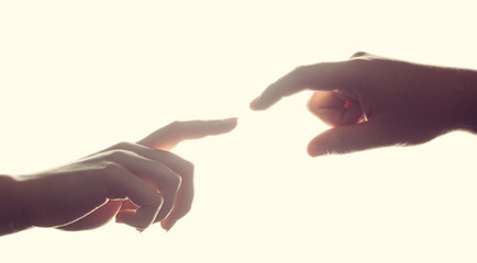 Man's and woman's hands, fingers reaching each other. Love, connect, help concepts.