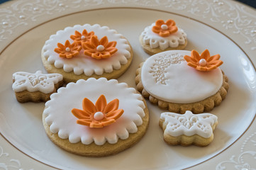 White butter cookies, decorated with orange flowers