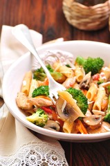 Pasta with chicken, broccoli, carrots, tomatoes and parmesan