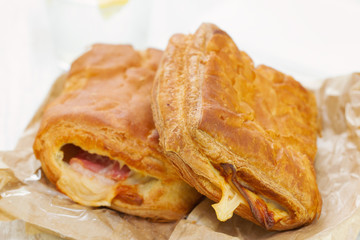 bread with ham and cheese with glass of water