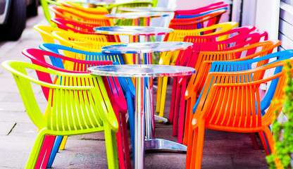 cafe summer terrace. cozy tables with red chairs