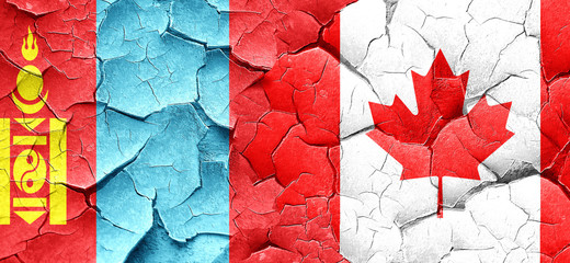 Mongolia flag with Canada flag on a grunge cracked wall