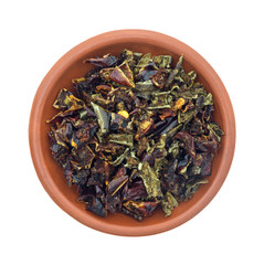 Dried red and green bell peppers in a small bowl isolated on a white background.