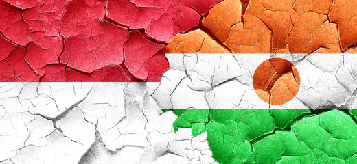 monaco flag with Niger flag on a grunge cracked wall