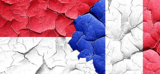 monaco flag with France flag on a grunge cracked wall
