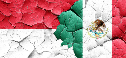 monaco flag with Mexico flag on a grunge cracked wall