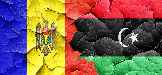 Moldova flag with Libya flag on a grunge cracked wall