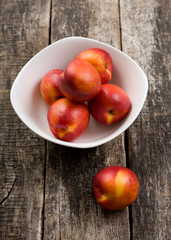 The simple food composition with nectarines on the unique backing closeup 
