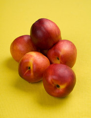 The simple food composition with nectarines on the unique backing closeup 