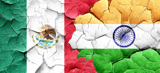mexico flag with India flag on a grunge cracked wall
