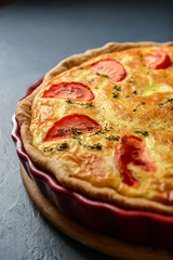 Close-up cropped photo of classic quiche lorraine pie with tomat