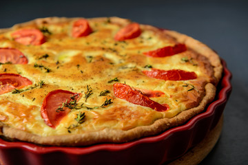 Close-up cropped photo of classic quiche lorraine pie with tomat