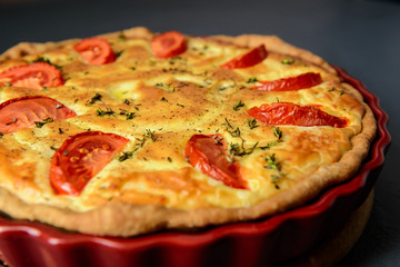 Close-up cropped photo of classic quiche lorraine pie with tomat