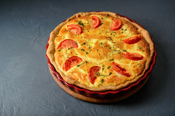Close-up photo of classic quiche lorraine pie with tomatoes