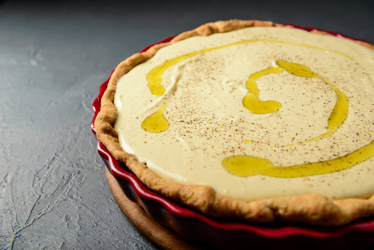 Close-up photo of tart with cream and olive oil