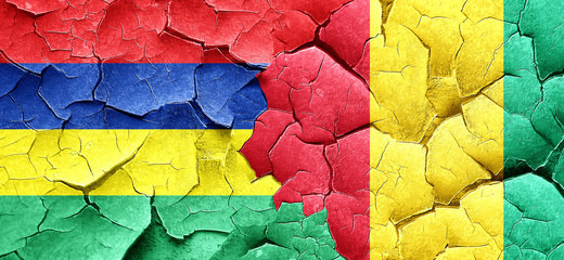 Mauritius flag with Guinea flag on a grunge cracked wall