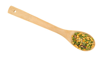 Minestrone soup mix in a spoon on a white background.
