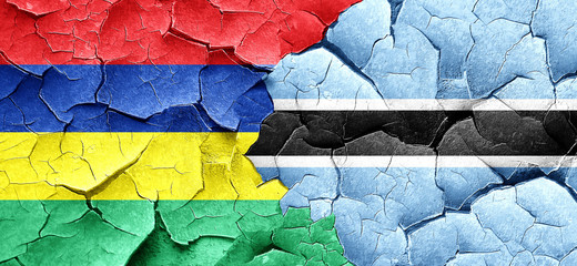 Mauritius flag with Botswana flag on a grunge cracked wall