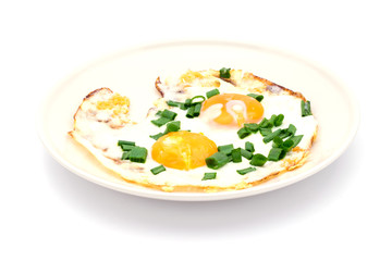 Two fried eggs with chives for healthy breakfast.