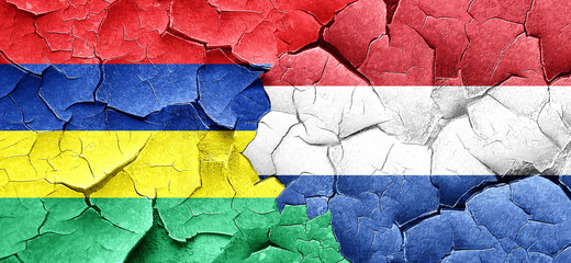 Mauritius flag with Netherlands flag on a grunge cracked wall