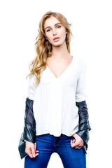 Portrait of young beautiful woman with black leather jacket. Long, light, wavy hair and makeup.