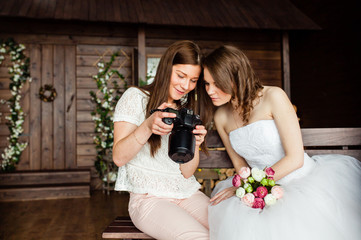 Young sexy photographer shows the bride had just taken photos