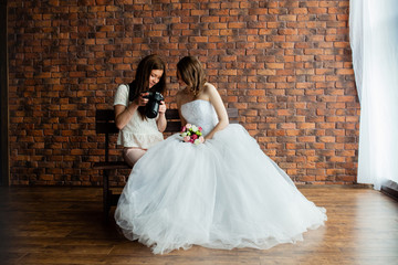 Young sexy photographer shows the bride had just taken photos