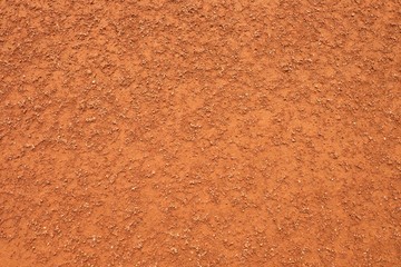 Dry red crushed bricks surface on tennis court