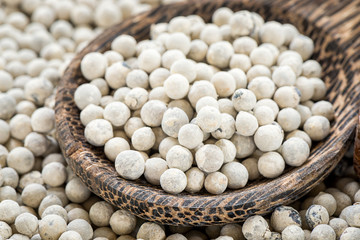 Closeup White  peppercorn wooden spoon