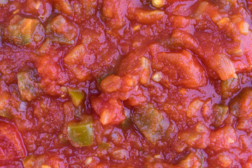 Close view of chunky salsa sauce in natural light.