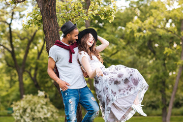 Couple standing and laughing outdoors
