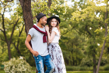 Beautiful young couple standing together in park