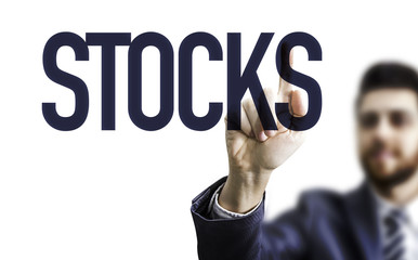 Business man pointing the word: Stocks